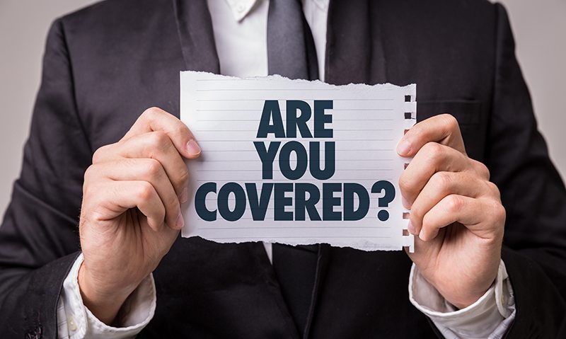 Man Holding Piece of Paper Saying Are You Covered