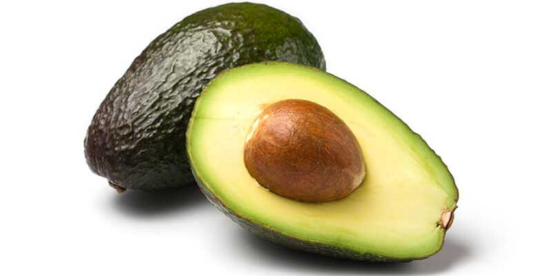 An image of an avocado sliced in half showing its nut